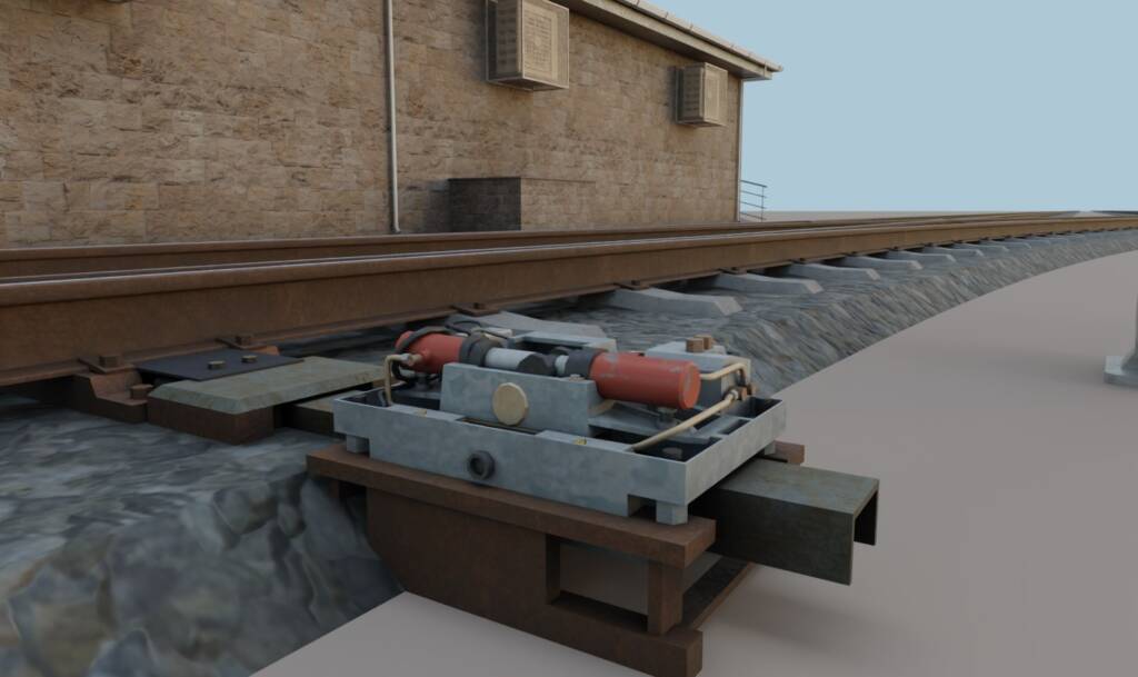 Railway point machine installed on track with metal structure and hydraulic components.